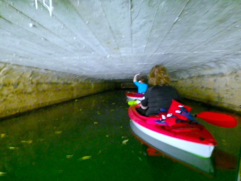 Guiding our boats through the tunnel with our hands while trying to avoid the ridiculous amount of spider webs.